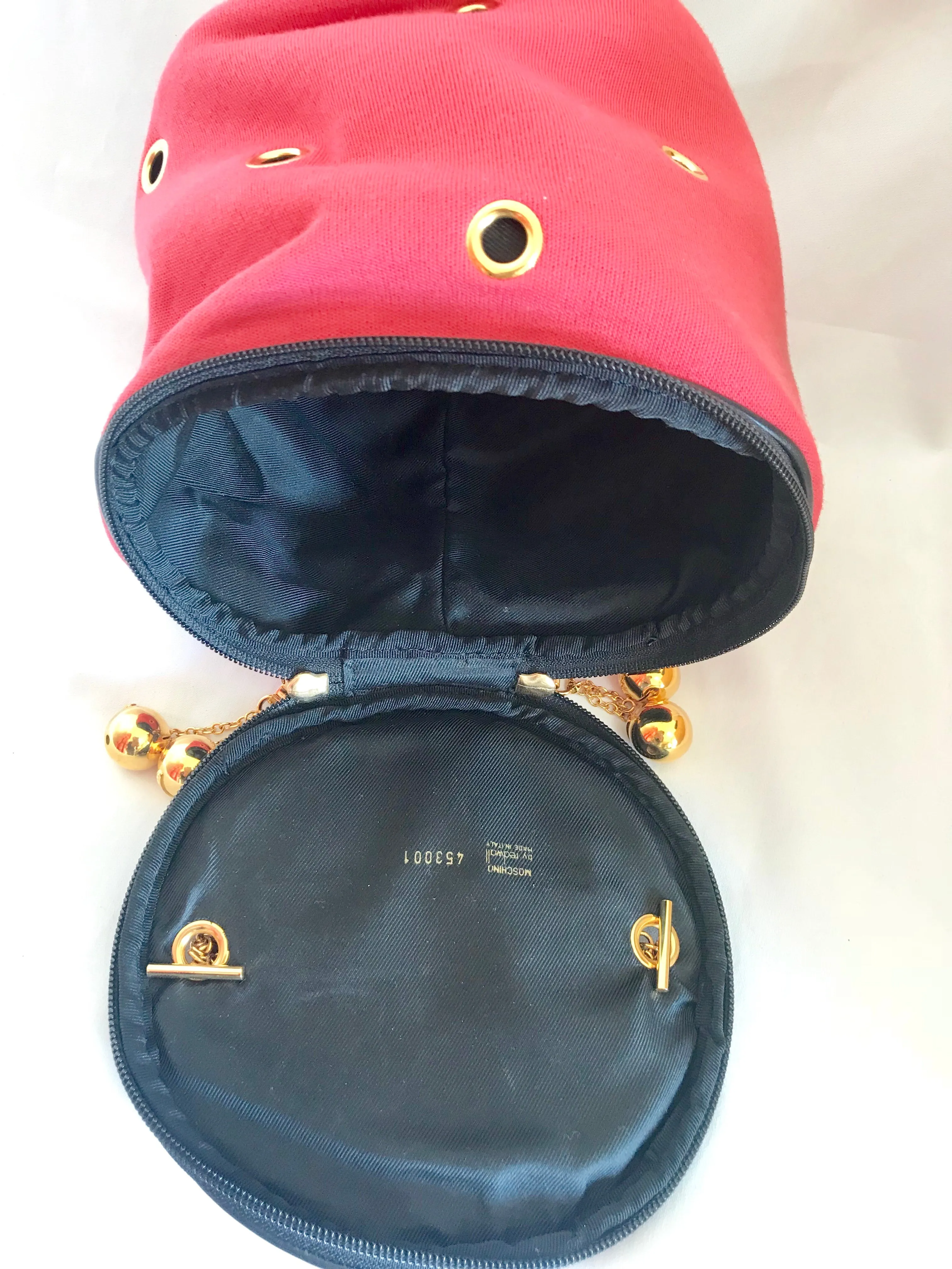 Vintage Moschino by Redwall lunchbox design red jersey and black leather handbag with golden eyelets and ball charms. 0506289