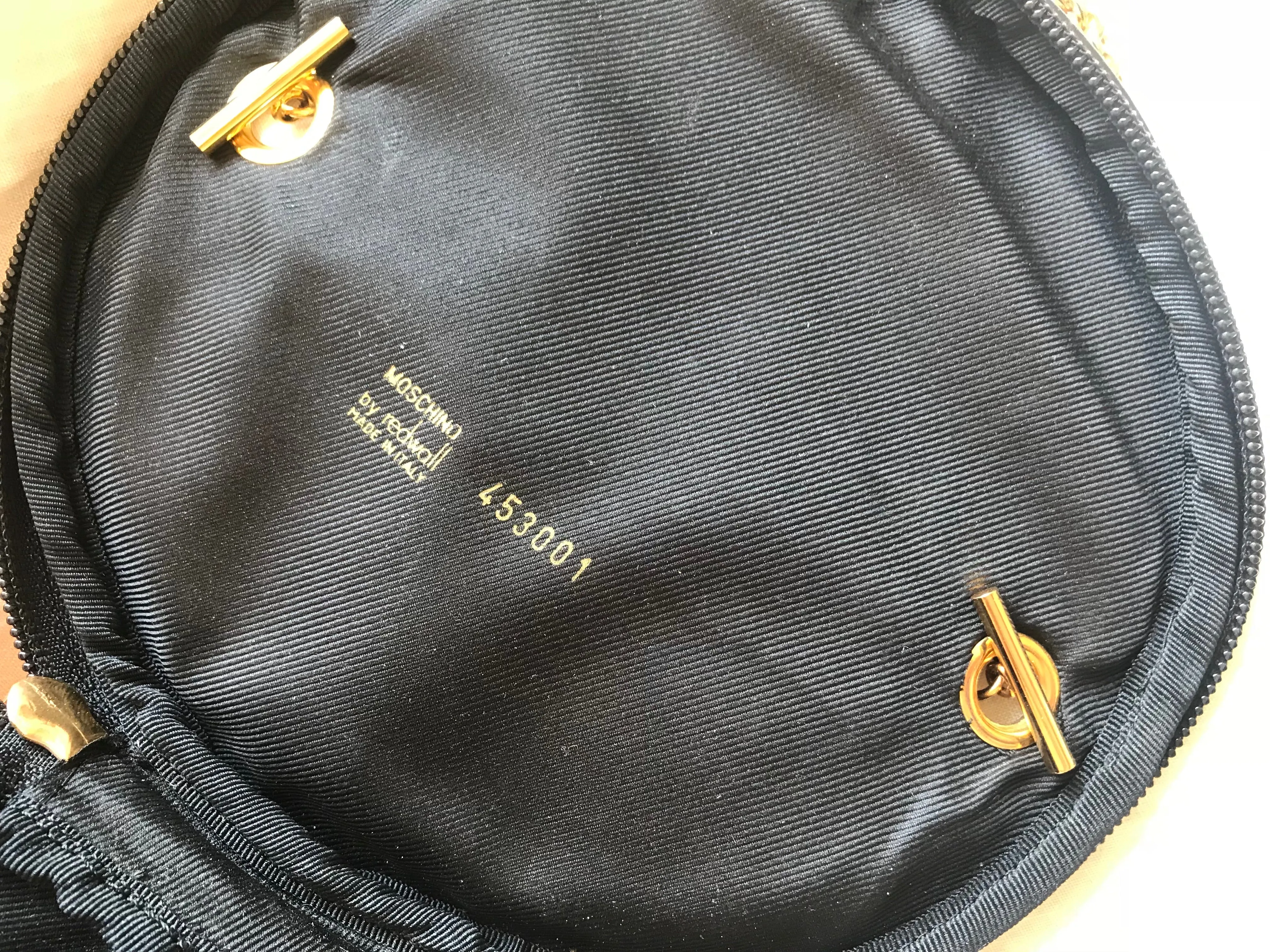 Vintage Moschino by Redwall lunchbox design red jersey and black leather handbag with golden eyelets and ball charms. 0506289